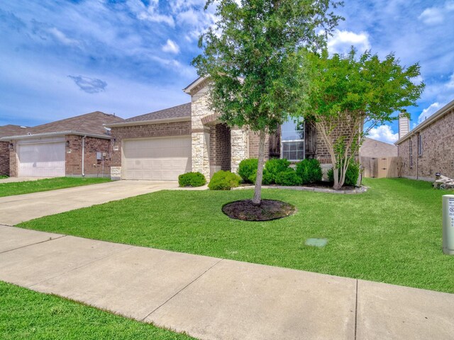 905 Jonius Creek Dr, Little Elm, TX 75068 - view of front facade with an attached garage, concrete driveway, a front lawn, brick siding, and stone siding