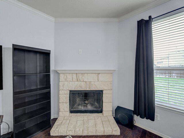 905 Jonius Creek Dr, Little Elm, TX 75068 - detailed view of wood finished floors, crown molding, a fireplace with raised hearth, and baseboards