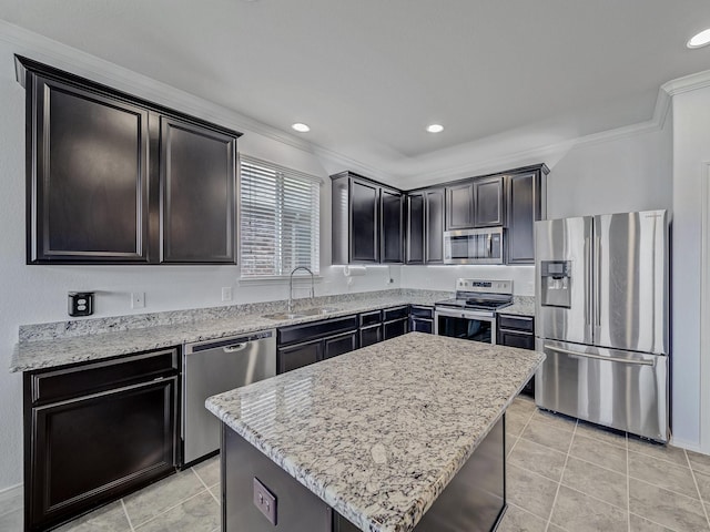 905 Jonius Creek Dr, Little Elm, TX 75068 - kitchen with appliances with stainless steel finishes, a sink, light tile patterned floors, ornamental molding, and light stone counters