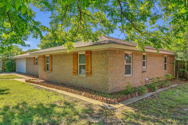 1507 Linda St, Bowie, TX 76230 - view of home's exterior with brick siding and a yard