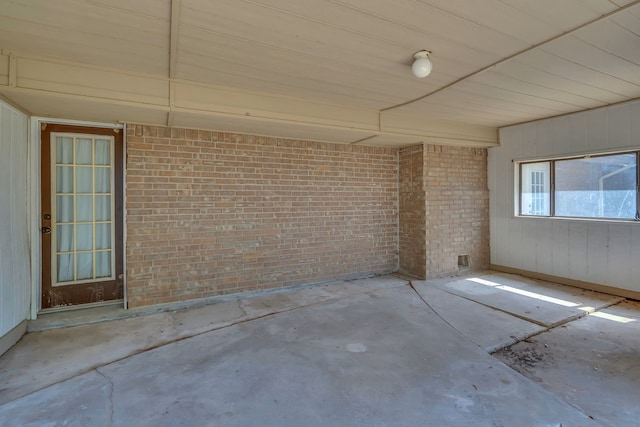 1507 Linda St, Bowie, TX 76230 - unfurnished room featuring unfinished concrete flooring and brick wall