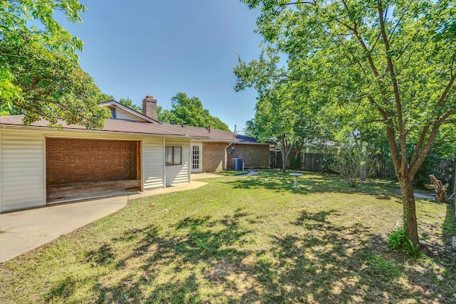 1507 Linda St, Bowie, TX 76230 - view of yard with cooling unit and an attached garage