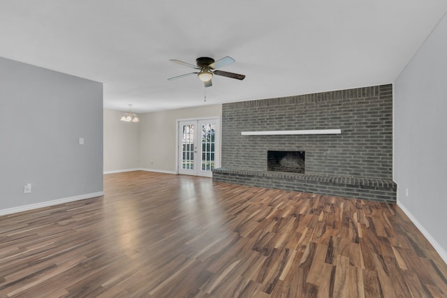 1507 Linda St, Bowie, TX 76230 - unfurnished living room with ceiling fan, wood finished floors, a chandelier, and baseboards