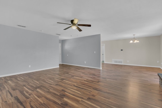 1507 Linda St, Bowie, TX 76230 - unfurnished room with a ceiling fan, wood finished floors, a chandelier, and baseboards
