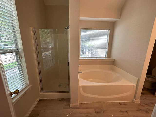 1026 Elm Dr, Providence Village, TX 76227 - bathroom with a stall shower, wood finished floors, a garden tub, and toilet