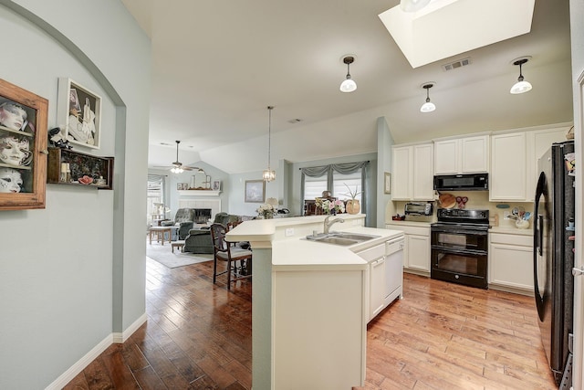 620 Cypress Hill Dr, Mckinney, TX 75071 - kitchen with black appliances, a sink, a fireplace, a ceiling fan, and vaulted ceiling