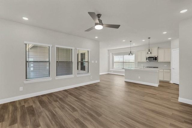 317 Boston Dr, Princeton, TX 74507 - unfurnished living room with a ceiling fan, wood finished floors, baseboards, and recessed lighting