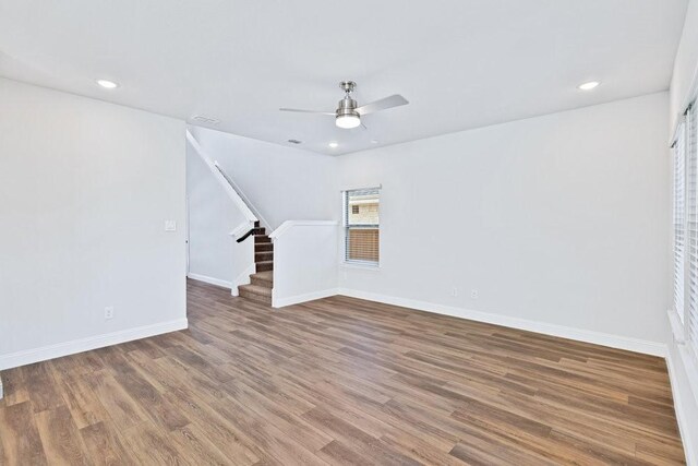 317 Boston Dr, Princeton, TX 74507 - unfurnished living room with stairs, ceiling fan, wood finished floors, baseboards, and recessed lighting