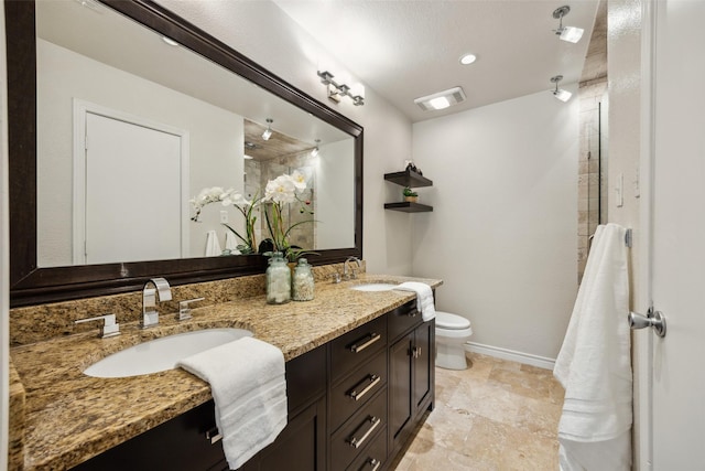 8803 Daytonia Ave, Dallas, TX 75218 - full bathroom featuring toilet, baseboards, double vanity, stone finish floors, and a shower