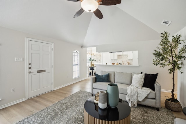 8803 Daytonia Ave, Dallas, TX 75218 - living room with light wood-style flooring, a ceiling fan, high vaulted ceiling, and baseboards