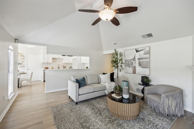 8803 Daytonia Ave, Dallas, TX 75218 - living area featuring light wood-style floors, a ceiling fan, baseboards, and high vaulted ceiling