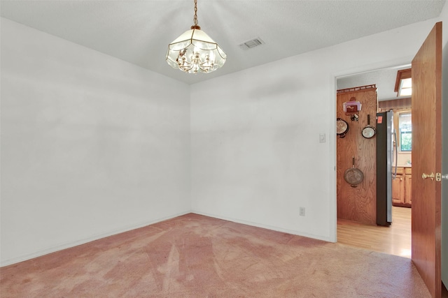 67 Melrose Cir, Denison, TX 75020 - empty room featuring a chandelier, light carpet, and baseboards