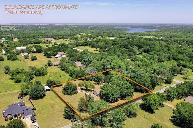 67 Melrose Cir, Denison, TX 75020 - aerial overview of property's location featuring a heavily wooded area, a large body of water, and property parcel outlined