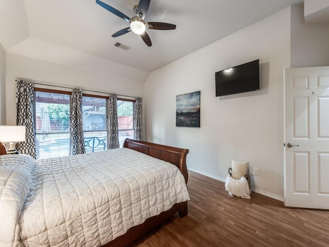 bedroom featuring baseboards, wood finished floors, lofted ceiling, access to exterior, and a ceiling fan