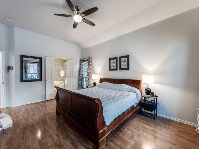 bedroom featuring wood finished floors, lofted ceiling, baseboards, and multiple windows