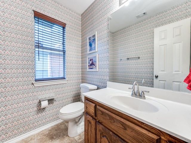 bathroom with wallpapered walls, toilet, tile patterned floors, vanity, and baseboards