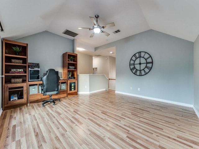 home office with vaulted ceiling, wood finished floors, a ceiling fan, and baseboards