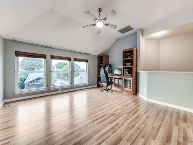 unfurnished office with a ceiling fan, lofted ceiling, wood finished floors, and baseboards