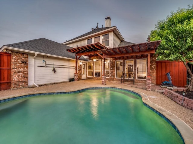 rear view of house featuring a pergola, a patio, fence, and brick siding