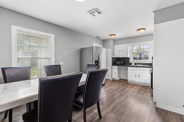 1709 Irving Lee St, Waco, TX 76711 - dining room featuring dark wood-style flooring and baseboards
