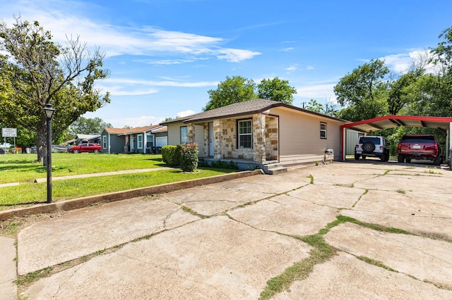 1709 Irving Lee St, Waco, TX 76711 - view of front of home featuring stone siding, concrete driveway, a front yard, and a detached carport