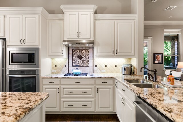 1417 Shenandoah Dr, Mckinney, TX 75071 - kitchen with appliances with stainless steel finishes, recessed lighting, under cabinet range hood, decorative backsplash, and white cabinets