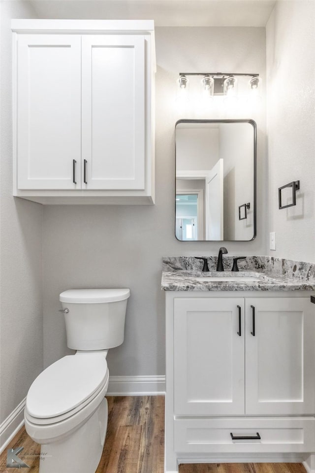 6718 Windmill Grass Ln, Abilene, TX 79606 - bathroom with baseboards, vanity, toilet, and wood finished floors