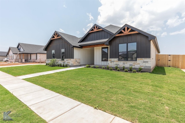 6718 Windmill Grass Ln, Abilene, TX 79606 - view of front facade featuring board and batten siding, roof with shingles, stone siding, and a gate