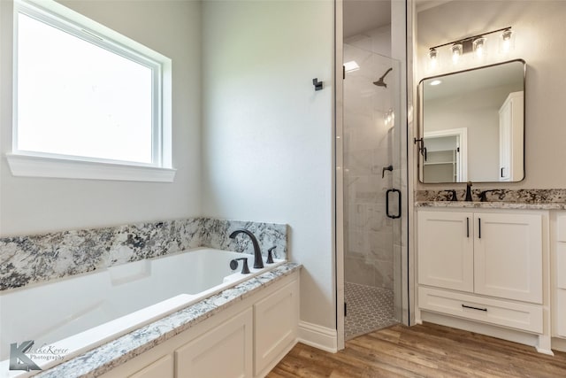 6718 Windmill Grass Ln, Abilene, TX 79606 - full bathroom featuring a shower stall, vanity, a garden tub, wood finished floors, and baseboards