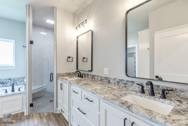 6718 Windmill Grass Ln, Abilene, TX 79606 - bathroom with a shower stall, double vanity, wood finished floors, and a tub