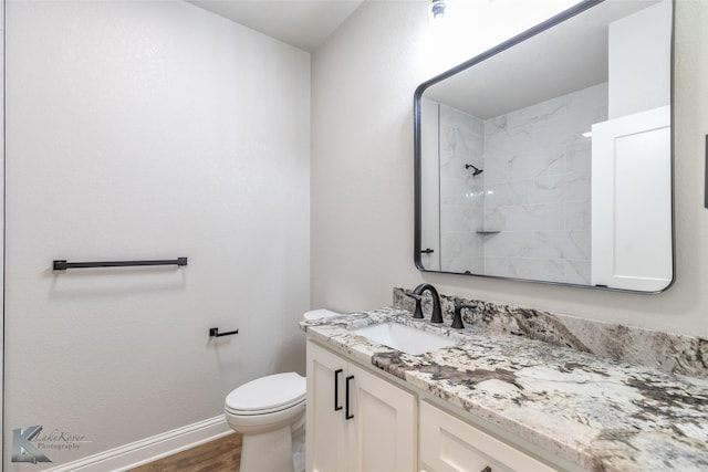 6718 Windmill Grass Ln, Abilene, TX 79606 - full bath with vanity, wood finished floors, toilet, tiled shower, and baseboards