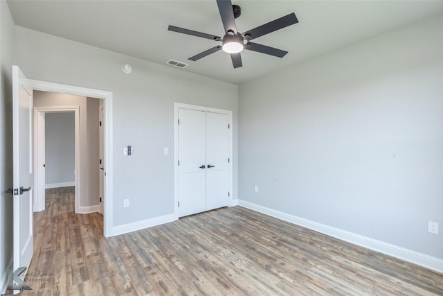 6718 Windmill Grass Ln, Abilene, TX 79606 - unfurnished bedroom featuring wood finished floors, baseboards, a closet, and ceiling fan