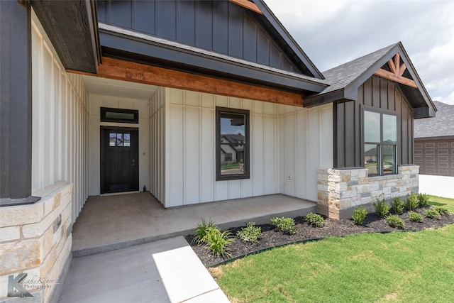 6718 Windmill Grass Ln, Abilene, TX 79606 - property entrance with board and batten siding, stone siding, a porch, and a yard