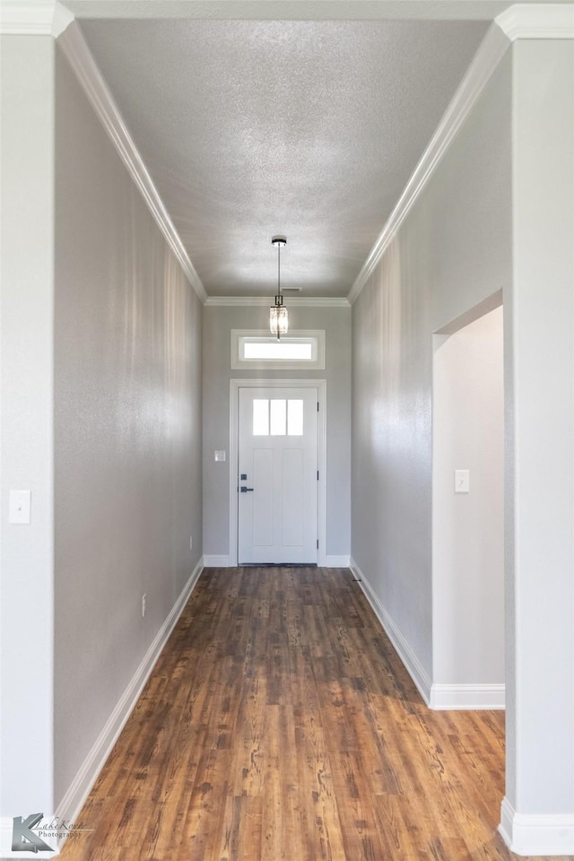 6718 Windmill Grass Ln, Abilene, TX 79606 - entryway with wood finished floors, a textured ceiling, baseboards, and ornamental molding