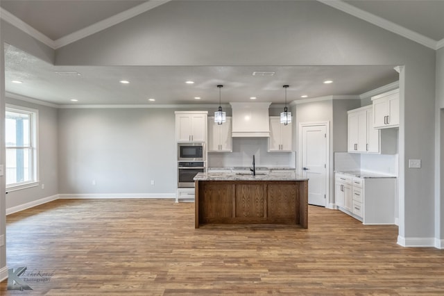 6718 Windmill Grass Ln, Abilene, TX 79606 - kitchen with oven, a sink, built in microwave, wood finished floors, and lofted ceiling