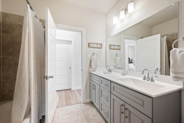 14320 Padden Park Ln, Fort Worth, TX 76262 - bathroom with double vanity, tile patterned flooring, a ceiling fan, ensuite bathroom, and baseboards