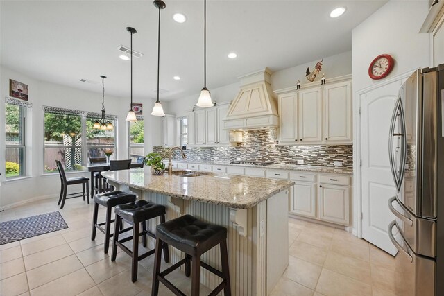3604 Mendocino Trl, Mckinney, TX 75070 - kitchen with stainless steel appliances, a sink, custom exhaust hood, tasteful backsplash, and light stone countertops