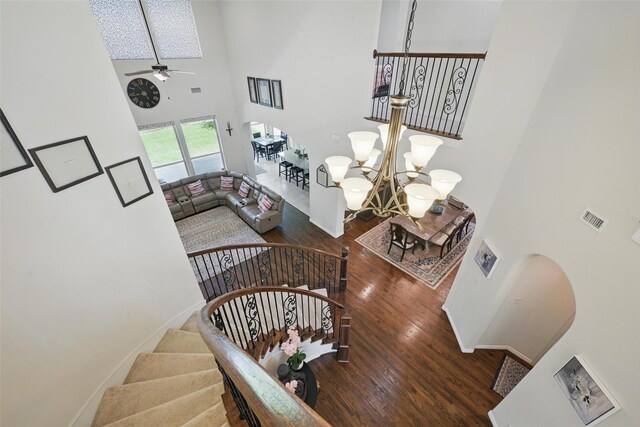 3604 Mendocino Trl, Mckinney, TX 75070 - stairway with a high ceiling, wood finished floors, a ceiling fan, arched walkways, and a chandelier