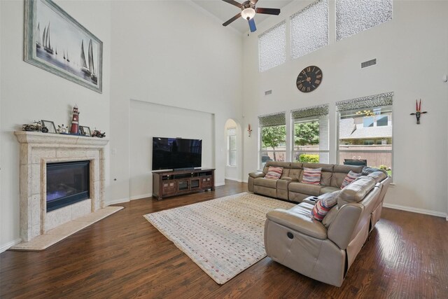 3604 Mendocino Trl, Mckinney, TX 75070 - living area featuring ceiling fan, a high ceiling, dark wood-style floors, a premium fireplace, and baseboards