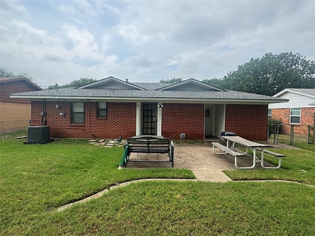 1213 Travis St, Garland, TX 75040 - back of property with cooling unit, brick siding, and roof with shingles