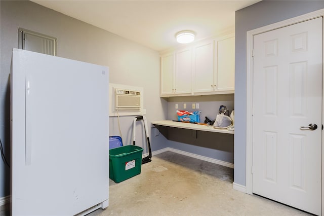 1003 E Burnett St, Ennis, TX 75119 - misc room with concrete flooring, a wall mounted air conditioner, and baseboards