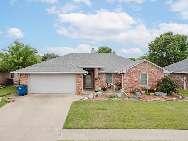 1003 E Burnett St, Ennis, TX 75119 - ranch-style house featuring roof with shingles, an attached garage, concrete driveway, a front lawn, and brick siding