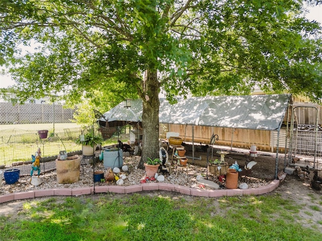 1003 E Burnett St, Ennis, TX 75119 - view of yard with exterior structure, fence, and an outbuilding