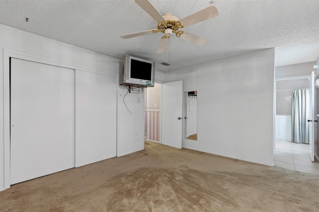 4611 Francis Ct, Granbury, TX 76049 - unfurnished bedroom with carpet flooring, a textured ceiling, a closet, a ceiling fan, and ensuite bathroom