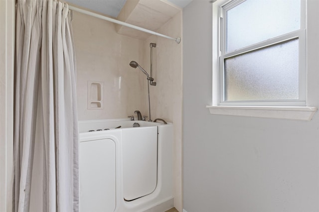 4611 Francis Ct, Granbury, TX 76049 - full bath featuring plenty of natural light, washer / clothes dryer, shower / bath combination with curtain, and baseboards