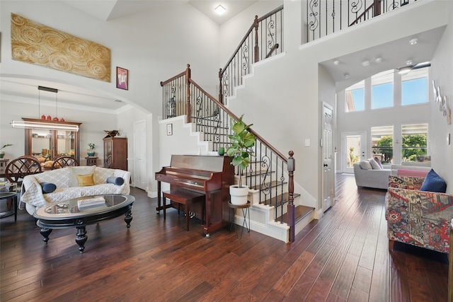 14766 Daneway Dr, Frisco, TX 75035 - stairway with a high ceiling, arched walkways, hardwood / wood-style floors, and baseboards