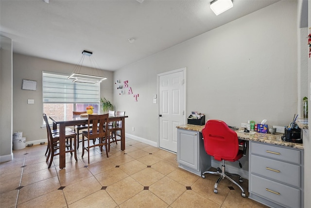 14766 Daneway Dr, Frisco, TX 75035 - office area with built in desk, baseboards, a chandelier, and light tile patterned floors