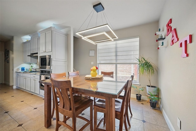 14766 Daneway Dr, Frisco, TX 75035 - dining room with light tile patterned floors, baseboards, and a chandelier