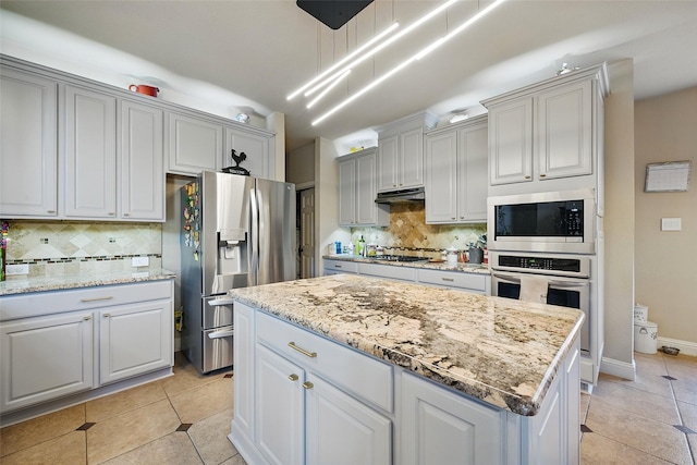14766 Daneway Dr, Frisco, TX 75035 - kitchen featuring stainless steel appliances, decorative backsplash, light stone countertops, and decorative light fixtures
