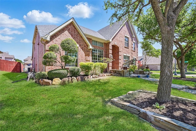 14766 Daneway Dr, Frisco, TX 75035 - view of front of property with brick siding, a front yard, and roof with shingles